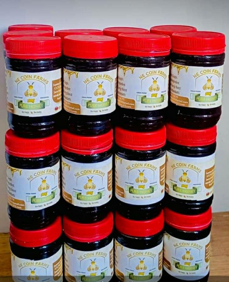 Jars of NE Coin Farms pure honey with branded packaging